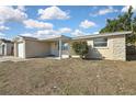 Cozy house with a stone facade, visible windows, and a small, simple front yard at 9111 Sterling Ln, Port Richey, FL 34668