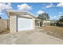 View of the attached garage with a clean white door and concrete driveway leading up to it at 9111 Sterling Ln, Port Richey, FL 34668