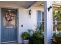 Inviting front door adorned with a wreath and surrounded by lush plants at 1091 Mcfarland St, Dunedin, FL 34698