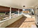 Relaxing covered patio featuring wood floors and views of the inviting backyard pool area at 1101 King Arthur Ct, Valrico, FL 33594