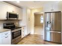 Modern kitchen with stainless steel appliances, granite counters, and white cabinets at 1101 King Arthur Ct, Valrico, FL 33594