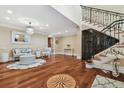 Inviting living room featuring hardwood floors, chandelier, and adjacent staircase with iron railing at 1336 51St Ne Ave, St Petersburg, FL 33703