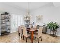 Bright dining room featuring a modern chandelier, plantation shutters, and stylish furnishings at 2028 Illinois Ne Ave, St Petersburg, FL 33703