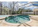 Sparkling screened-in pool and spa area with brick paver deck, perfect for outdoor entertaining and relaxation at 212 Arbor Woods Cir, Oldsmar, FL 34677