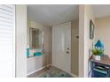 Cozy entryway with decorative mirror, console table, tiled floors and charming accents at 217 S Mcmullen Booth Rd # 179, Clearwater, FL 33759