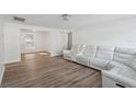 Open-concept living room featuring new flooring, freshly painted walls, and ample seating at 2195 Glen Dr, Safety Harbor, FL 34695