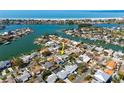 Breathtaking aerial view of waterfront property near the beach, surrounded by lush landscaping at 230 S Julia Cir, St Pete Beach, FL 33706