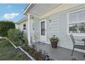 Inviting front porch with decorative plants and a cozy seating area, enhancing curb appeal at 2419 Palmwood Dr, Holiday, FL 34690