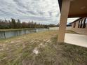 A serene backyard with a lake view and a black aluminum fence at 2827 Shetland Ridge Dr, Valrico, FL 33596