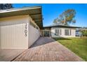 Beautiful home showcasing a brick walkway, a well-kept lawn, and a modern exterior design at 2905 Bay St, Sarasota, FL 34237