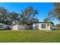 Inviting home with a lush green lawn and a welcoming front facade, perfect for Gathering living at 2905 Bay St, Sarasota, FL 34237