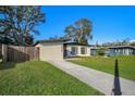 Charming home featuring a well-manicured lawn and a concrete driveway leading to a garage at 2905 Bay St, Sarasota, FL 34237