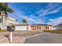 Charming single-story home with a two-car garage, decorative stone accents, and a well-manicured front lawn at 3939 Rudder Way, New Port Richey, FL 34652