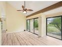 Bright living room with wood-look floors, vaulted ceiling, ceiling fan and sliding glass doors at 4307 Woodmans Chart # 132, Sarasota, FL 34235