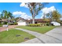 Charming single-story home featuring a manicured lawn and beautiful brick driveway at 4309 Deepwater Ln, Tampa, FL 33615