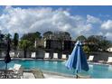 Community pool with lounge chairs offering relaxing poolside experience at 4515 Whitton Way # 121, New Port Richey, FL 34653