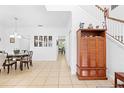 Bright, tiled hallway featuring elegant furniture, wall décor, and staircase at 5147 Elwood Rd, Spring Hill, FL 34608