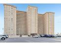 An exterior shot of a high-rise building showcasing multiple stories and parking area at 5200 Brittany S Dr # 902, St Petersburg, FL 33715