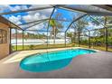 Inviting screened-in pool with a relaxing outdoor space and blue skies above at 5327 N Cranberry Blvd, North Port, FL 34286