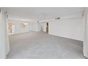 Expansive living room featuring a ceiling fan, light-colored walls and carpeting with open access to the kitchen at 700 Starkey Rd # 914, Largo, FL 33771