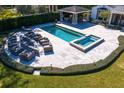 Aerial shot of a stunning outdoor area, including a pool, spa, fire pit, and covered bar area at 1002 S Frankland Rd, Tampa, FL 33629