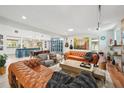 Open-concept living room and kitchen with sleek furniture, modern decor, and lots of natural light at 105 Country Villas Dr, Safety Harbor, FL 34695