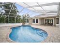 Inviting screened-in pool area with pavers and ample seating space for relaxing and entertaining at 11505 Heron Hills Ln, Riverview, FL 33569