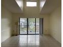 Bright living room with high ceilings and sliding glass doors to balcony at 1308 Pine Ridge E Cir # E3, Tarpon Springs, FL 34688
