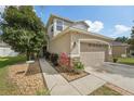 Inviting two-story home with a stone-accented garage and beautifully landscaped front yard at 15701 Greyrock Dr, Spring Hill, FL 34610