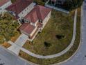 Aerial shot showcases the property, manicured lawn, landscaping, and surrounding neighborhood at 19609 Timberbluff Dr, Land O Lakes, FL 34638