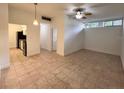 An open concept living room with tile floors leads to the kitchen with black appliances at 2401 Bayshore Blvd # 101, Tampa, FL 33629