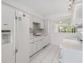 Updated kitchen with white cabinets, modern appliances, and a stylish backsplash at 2700 Cove Cay Dr # 4-B, Clearwater, FL 33760