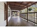 Inviting covered porch with wood flooring, perfect for outdoor lounging at 3307 Fox Ridge Blvd, Wesley Chapel, FL 33543