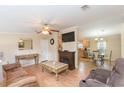 Inviting living room with wood floors, a fireplace, and an open layout connecting to the kitchen and dining area at 36246 Peak St, Zephyrhills, FL 33541