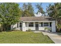 Charming one-story home with a well-maintained lawn and a neatly landscaped front yard at 3915 N Ola Ave, Tampa, FL 33603