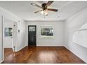 Bright living room with hardwood floors, a ceiling fan, and a large window offering natural light at 3915 N Ola Ave, Tampa, FL 33603