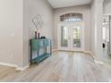 Bright foyer features wood-look tile flooring and decorative double-door entryway, creating an inviting ambiance at 4421 Larkenheath Dr, Spring Hill, FL 34609