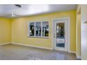 Bright room with neutral paint, tile flooring, and natural light from large windows at 4550 Plaza Way, St Pete Beach, FL 33706