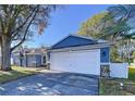 Inviting single-story home with a two-car garage, nicely landscaped yard, and great curb appeal at 8600 Berkley Dr, Hudson, FL 34667