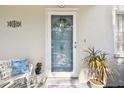 Close-up of the front door, featuring a decorative welcome sign and a charming seating area at 11124 Corlett Rd, Riverview, FL 33578