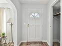Hallway view of interior door with a sunburst window and convenient access to storage at 11124 Corlett Rd, Riverview, FL 33578