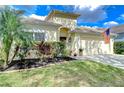 Inviting one-story home with lush landscaping, a palm tree, and a neatly maintained lawn at 1168 Emerald Hill Way, Valrico, FL 33594