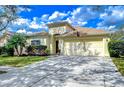 Charming one-story home featuring a well-manicured lawn, lush landscaping, and a two-car garage at 1168 Emerald Hill Way, Valrico, FL 33594