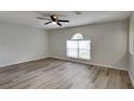 A bright living room is illuminated by a window and features new plank floors at 13506 Copper Head Dr, Riverview, FL 33569