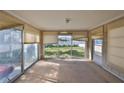 Empty sunroom featuring large windows overlooking the green backyard, ready for customization at 15548 1St E St, Redington Beach, FL 33708