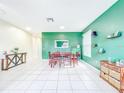 Bright dining room featuring tile floors, green accent walls and plenty of natural light at 1609 Shady Oaks Dr, Oldsmar, FL 34677