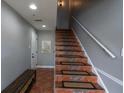 Hallway featuring a staircase with decorative tile, a bench, and neutral-colored walls at 219 126Th Ave, Treasure Island, FL 33706