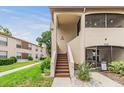 Welcoming exterior showcasing a two-story home, neat landscaping, and a screened in porch for outdoor enjoyment at 2983 Bonaventure Cir # 204, Palm Harbor, FL 34684