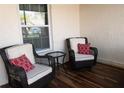 Relaxing front porch with wicker chairs and a small table with a view to the window at 3942 La Costa Ln, Largo, FL 33771