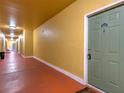 Condo hallway featuring unit door with number and view down length of the hall, displaying building interior at 4207 S Dale Mabry Hwy # 6207, Tampa, FL 33611